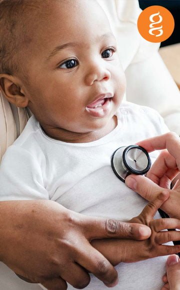 Baby's heart being checked with a stethoscope